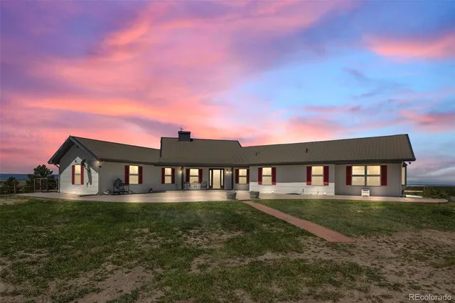 a view of a big house with a yard