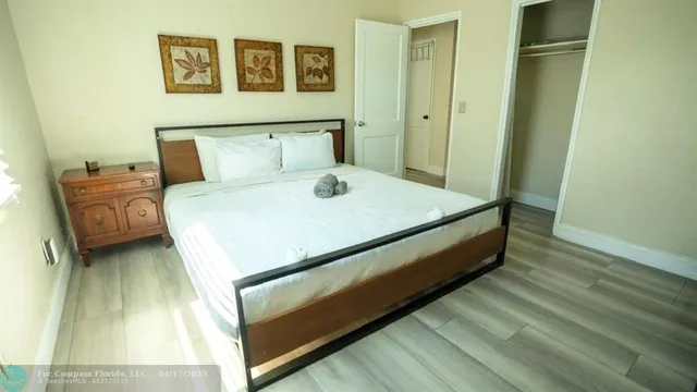 a bed sitting in a bedroom next to a bathroom