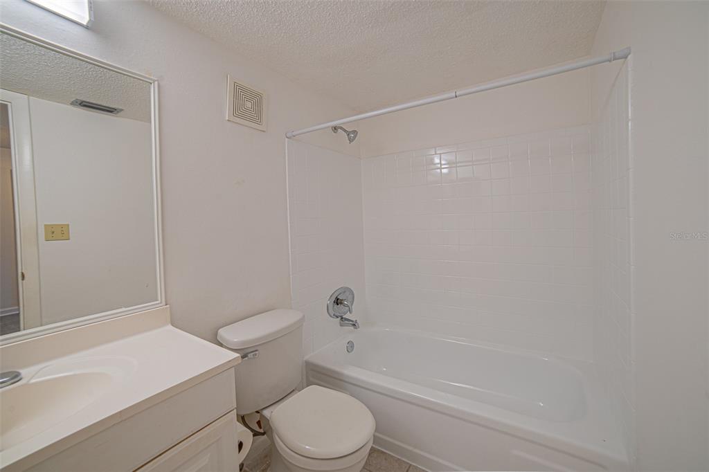 629 North Keene Road, Unit T11 Clearwater, FL 33755 - Photo 11 of 16 a bathroom with a sink a toilet and shower