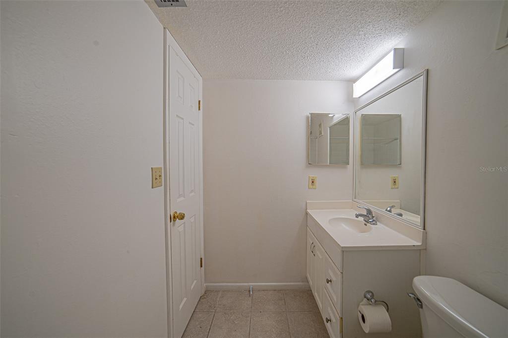 629 North Keene Road, Unit T11 Clearwater, FL 33755 - Photo 12 of 16 a bathroom with a sink a toilet and shower