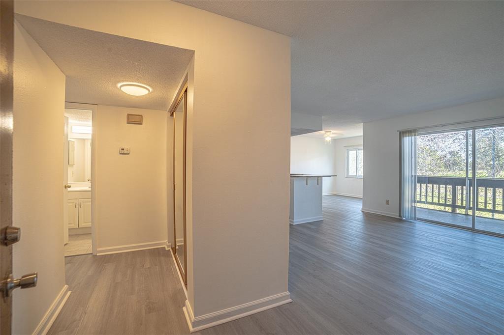 629 North Keene Road, Unit T11 Clearwater, FL 33755 - Photo 4 of 16 wooden floor in an empty room with a window