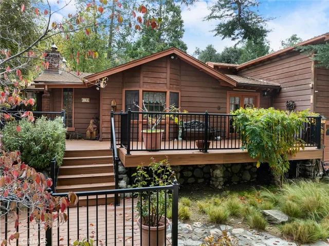 a view of a house with wooden deck and furniture