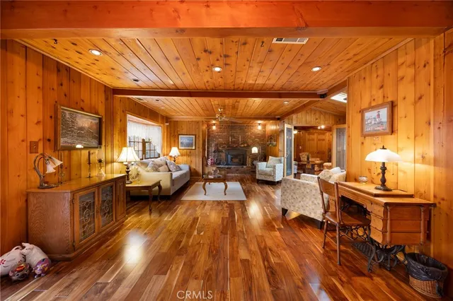 a view of a living room with furniture and a fireplace