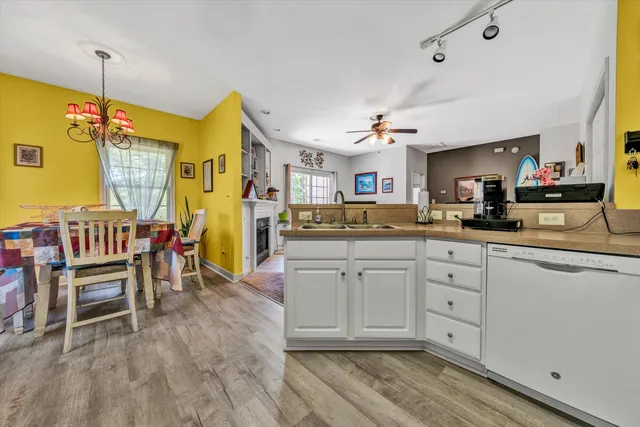 a kitchen with cabinets and chairs