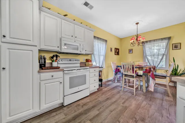 a kitchen with a white cabinets and stove top oven
