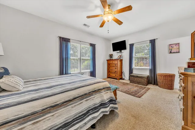 a bedroom with a bed and dresser with mirror