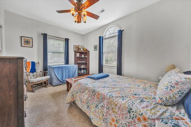 a bedroom with a bed dresser and a window