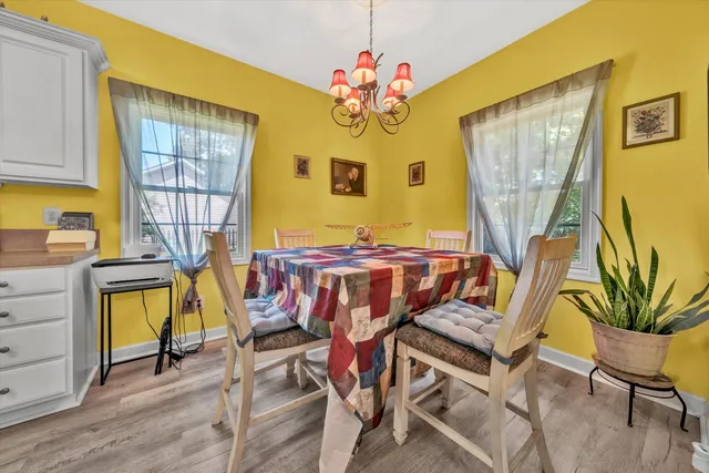 a view of a dining room with furniture and a chandelier