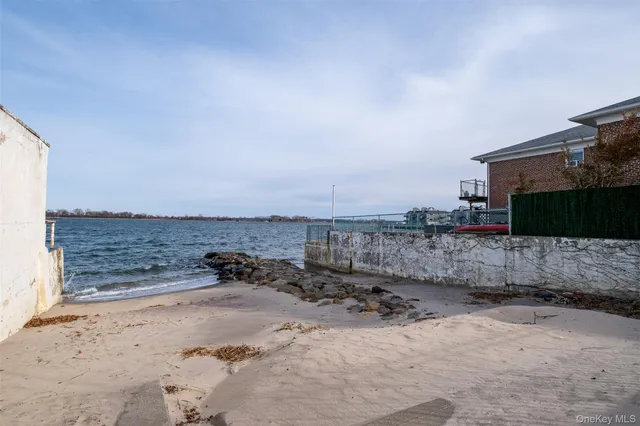 a view of a dry yard with wooden fence