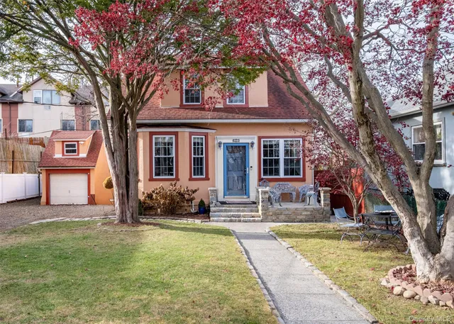 a house that has a tree in front of the house