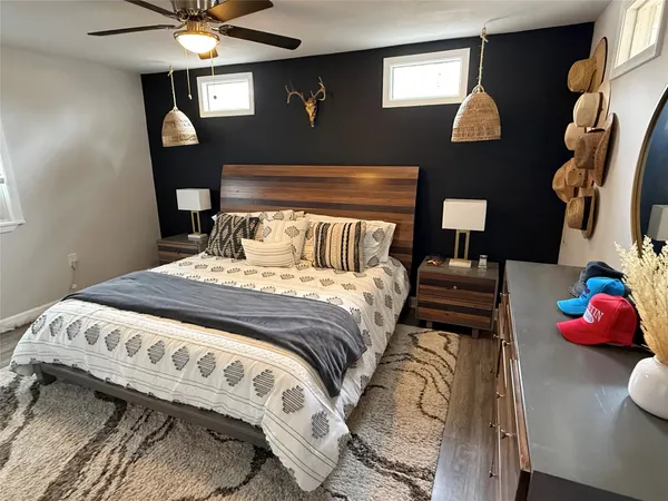 a bedroom with a bed and a chandelier