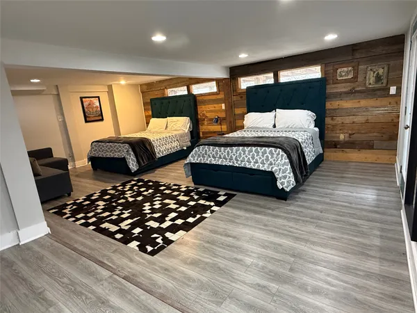 a bedroom with double bed and a couch