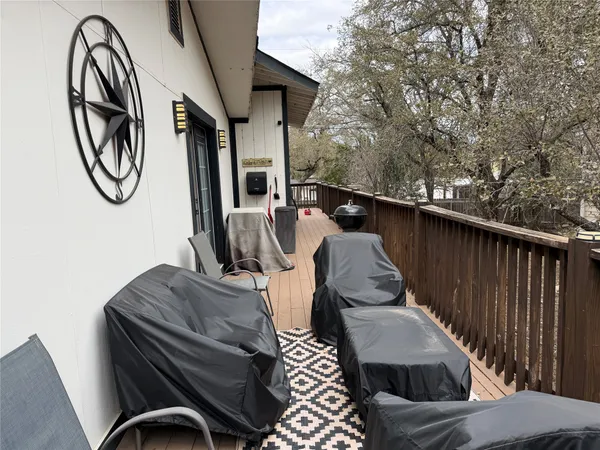 a view of balcony with wooden floor and seating space