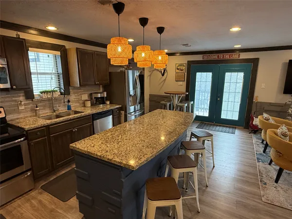 a kitchen with a table chairs and wooden floor