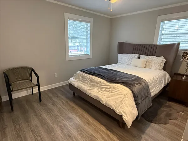 a bedroom with a bed chair and window