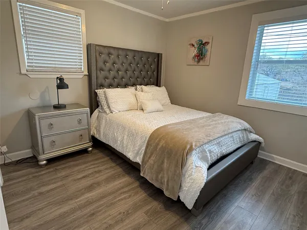 a large bed sitting in a bedroom next to a window