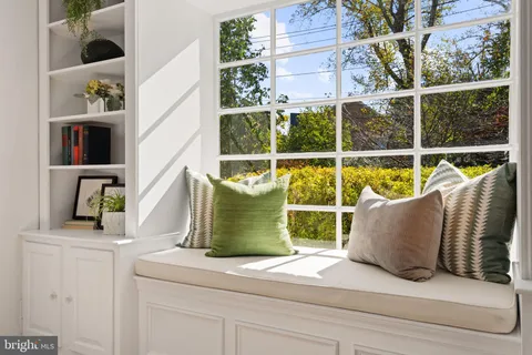 a view of a dining room with furniture wooden floor and a chandelier