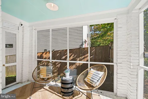 a view of a dining room with furniture a chandelier and wooden floor
