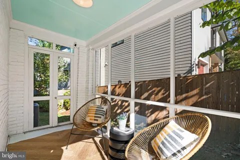 a kitchen with a sink a stove top oven and white cabinets