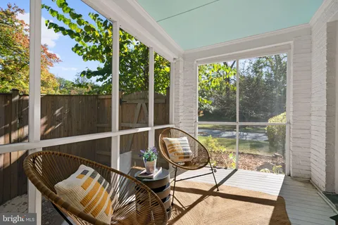 a kitchen with granite countertop a refrigerator oven a sink dishwasher and white cabinets with wooden floor