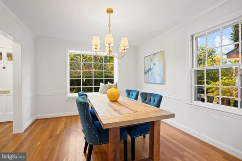 a living room with furniture and floor to ceiling windows