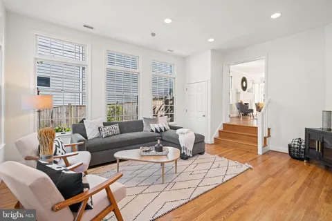a bedroom with a bed and a table with wooden floor