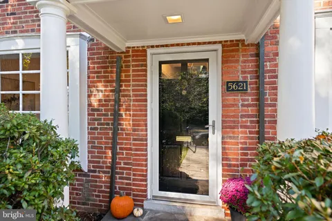 a living room with furniture and a mirror