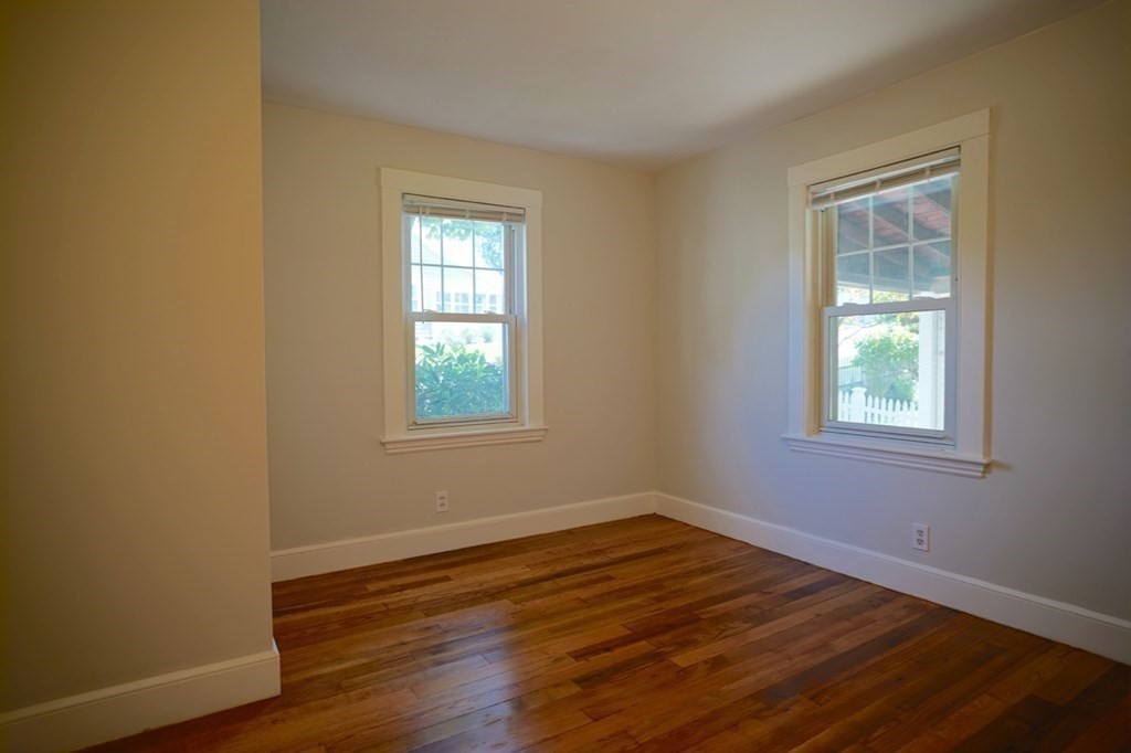 24 Peach Highlands Marblehead, MA 01945 - Photo 11 of 42 a view of an empty room with wooden floor and a window