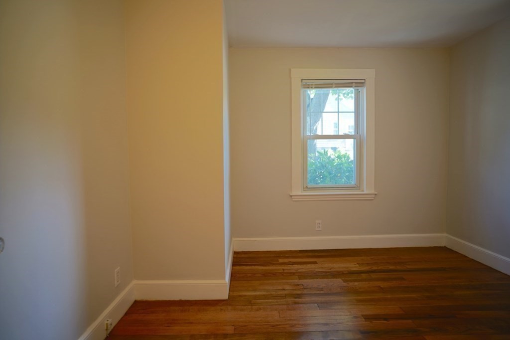 24 Peach Highlands Marblehead, MA 01945 - Photo 12 of 42 a view of an empty room with wooden floor and a window