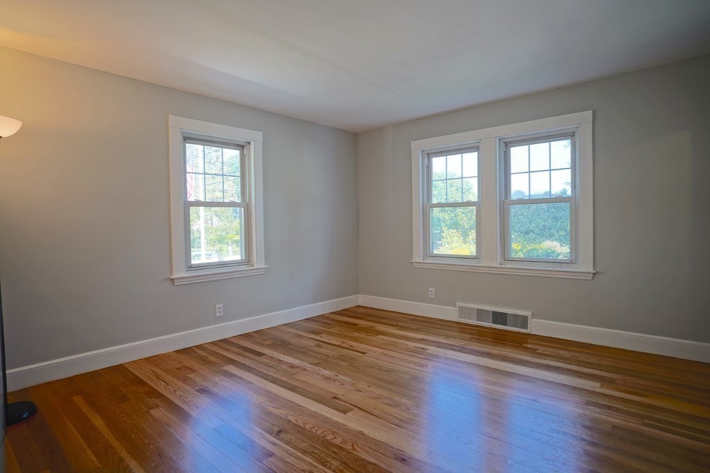 24 Peach Highlands Marblehead, MA 01945 - Photo 14 of 42 an empty room with wooden floor and windows