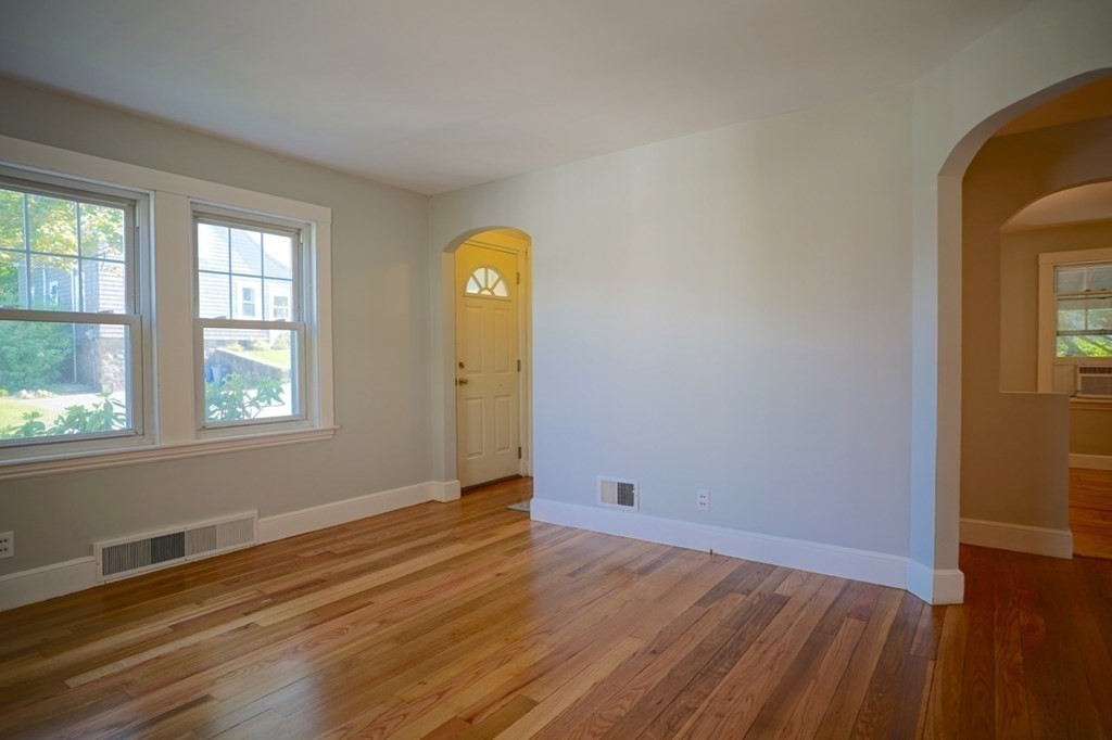 24 Peach Highlands Marblehead, MA 01945 - Photo 16 of 42 an empty room with wooden floor and windows