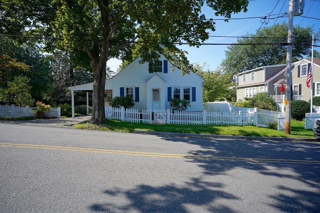24 Peach Highlands Marblehead, MA 01945 - Photo 3 of 42 a front view of a house with a yard and garage