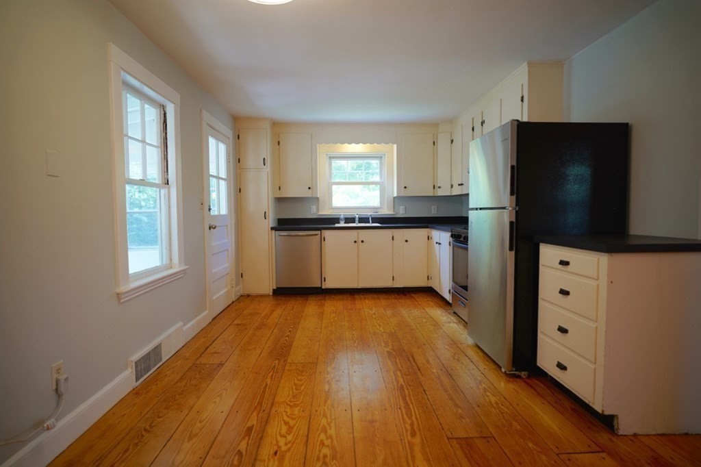 24 Peach Highlands Marblehead, MA 01945 - Photo 6 of 42 a kitchen with granite countertop a stove top oven a sink dishwasher and a refrigerator