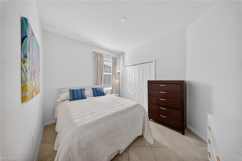2196 Dragonfruit Way Naples, FL 34120 - Photo 11 of 50 a bedroom with a bed and lamps
