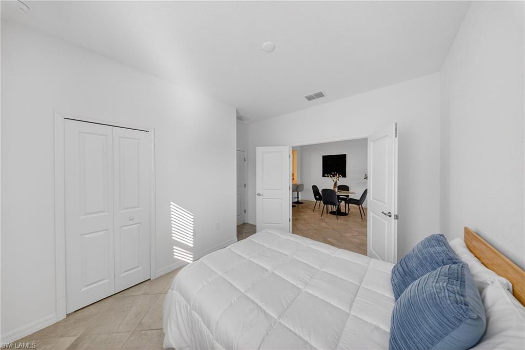 2196 Dragonfruit Way Naples, FL 34120 - Photo 12 of 50 a bedroom with a bed and furniture