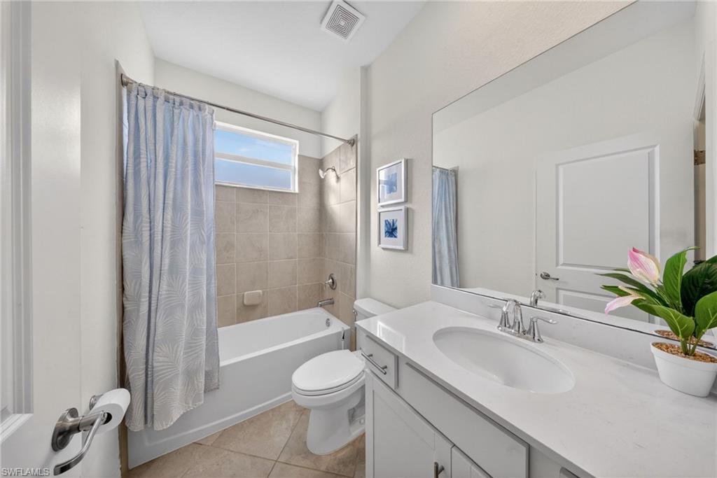 2196 Dragonfruit Way Naples, FL 34120 - Photo 13 of 50 a bathroom with a granite countertop sink a toilet a shower and a mirror