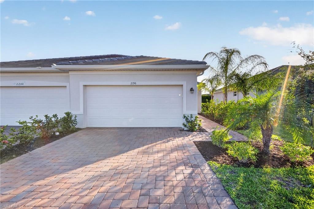 2196 Dragonfruit Way Naples, FL 34120 - Photo 3 of 50 a front view of a house with garden