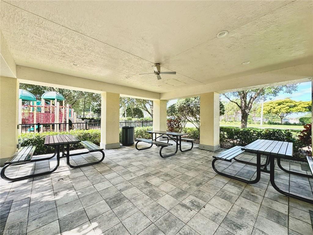 2196 Dragonfruit Way Naples, FL 34120 - Photo 32 of 50 a living room with furniture and floor to ceiling windows