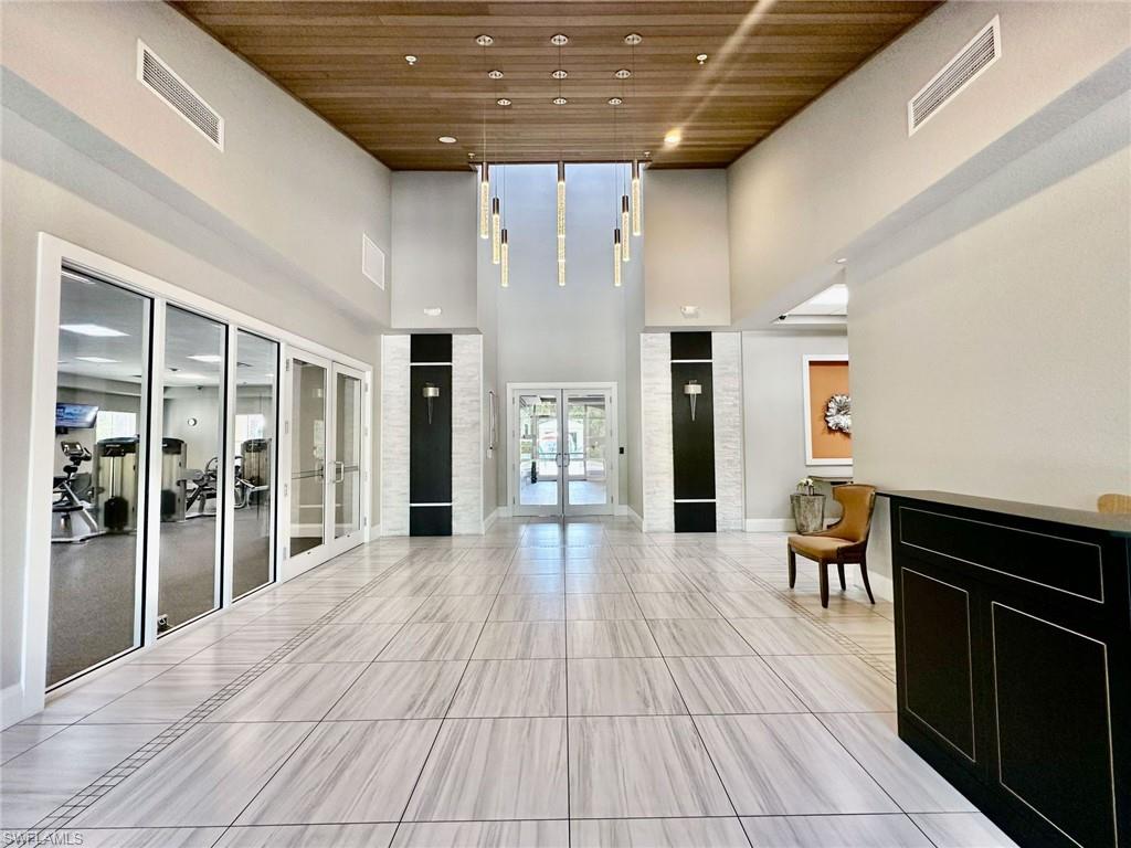 2196 Dragonfruit Way Naples, FL 34120 - Photo 47 of 50 a lobby with furniture and wooden floor