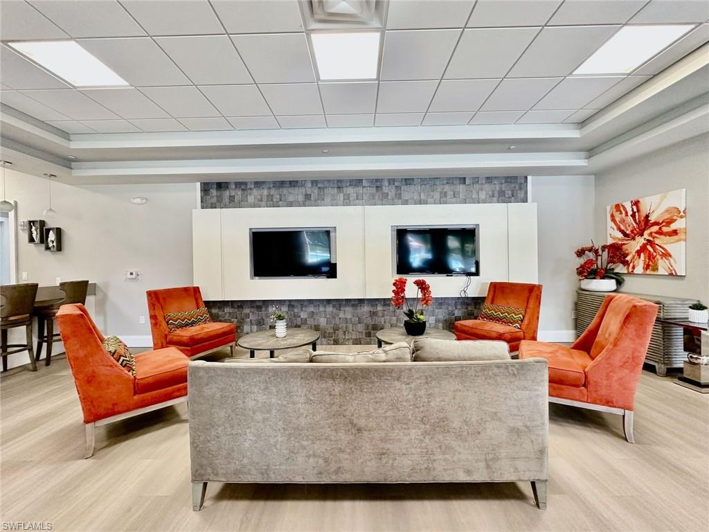 2196 Dragonfruit Way Naples, FL 34120 - Photo 49 of 50 a living room with furniture and a flat screen tv