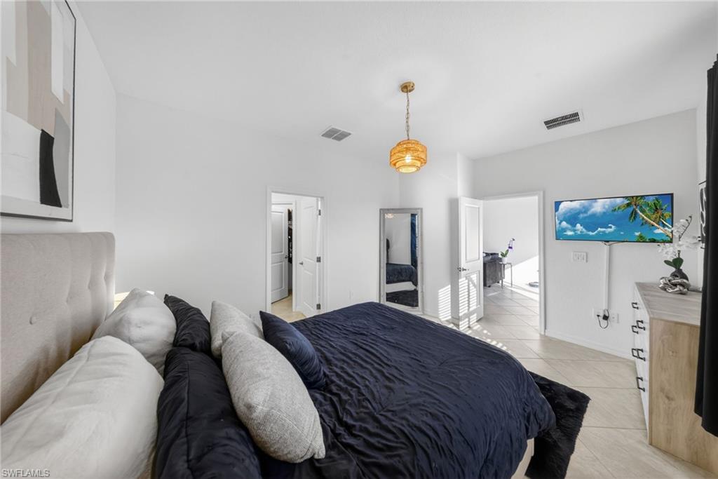 2196 Dragonfruit Way Naples, FL 34120 - Photo 8 of 50 a bedroom with a bed and wooden floor