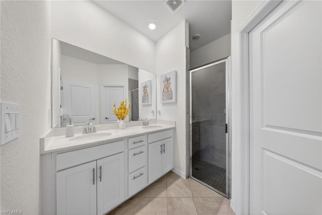 2196 Dragonfruit Way Naples, FL 34120 - Photo 10 of 50 a bathroom with a double vanity sink and mirror