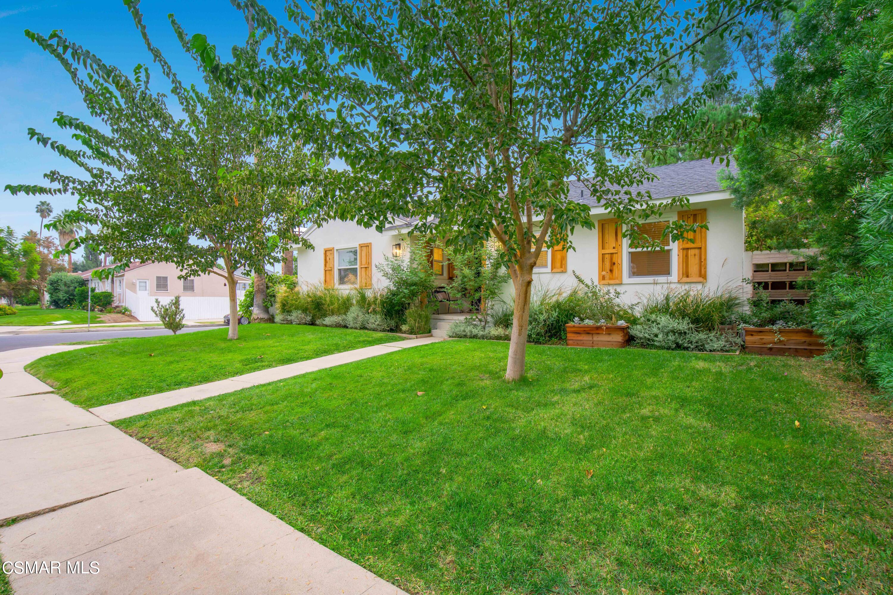 6552 Comanche Avenue Winnetka, CA 91306 - Photo 2 of 20 a front view of house with yard and green space