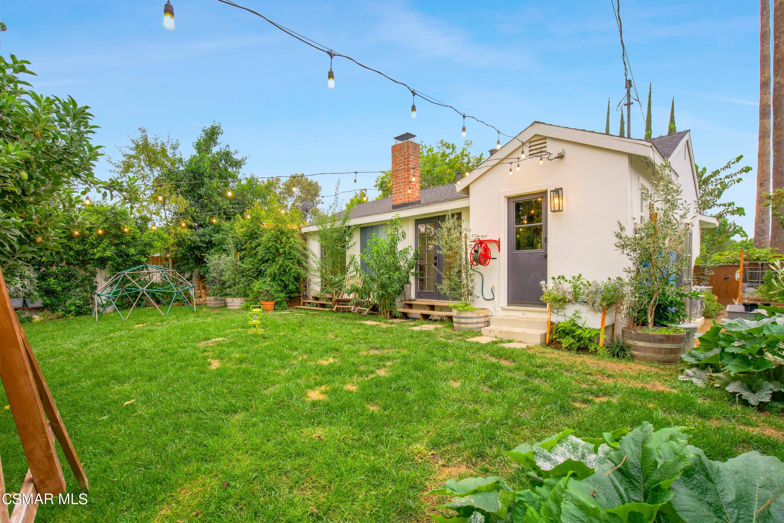 6552 Comanche Avenue Winnetka, CA 91306 - Photo 19 of 20 a view of a house with backyard sitting area and garden
