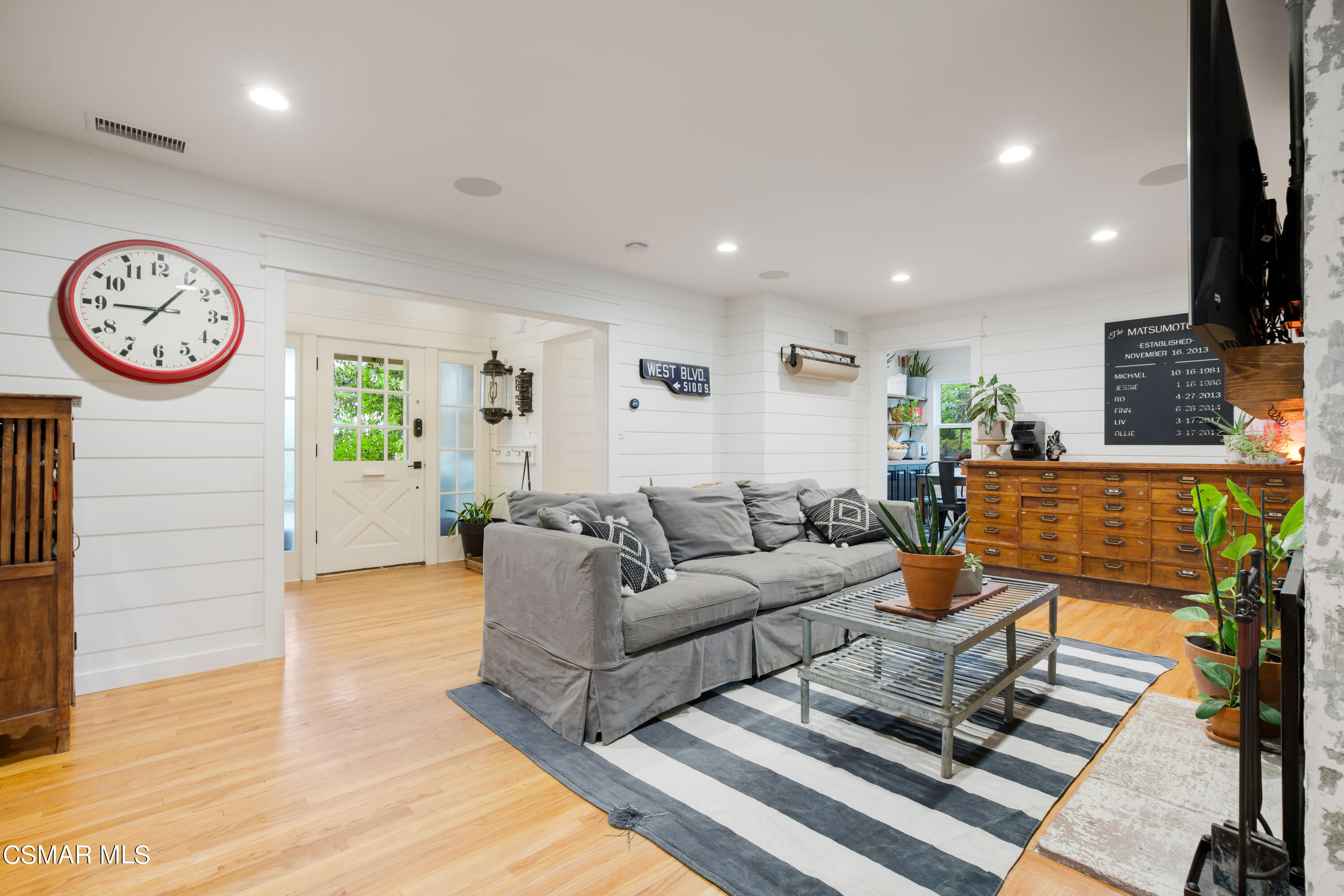 6552 Comanche Avenue Winnetka, CA 91306 - Photo 6 of 20 a living room with furniture a clock and a view of kitchen