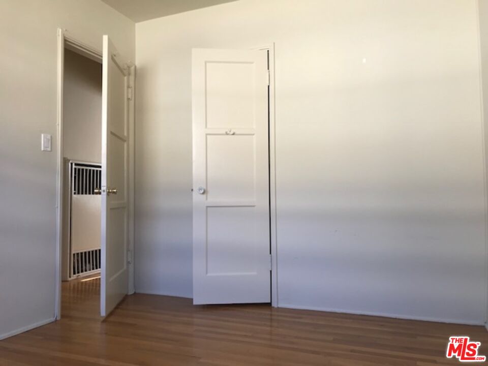 1927 Butler Avenue Los Angeles, CA 90025 - Photo 16 of 19 a view of empty room with wooden floor