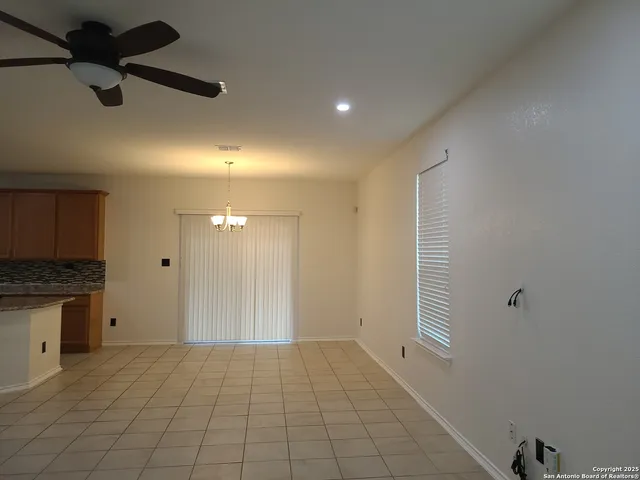 wooden floor in an empty room with a kitchen