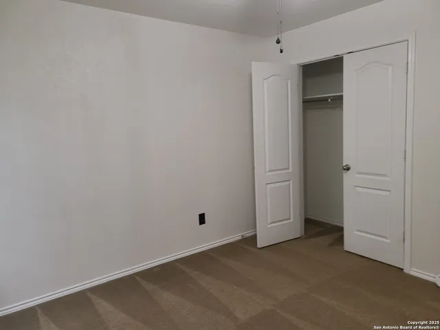 an empty room with closet area