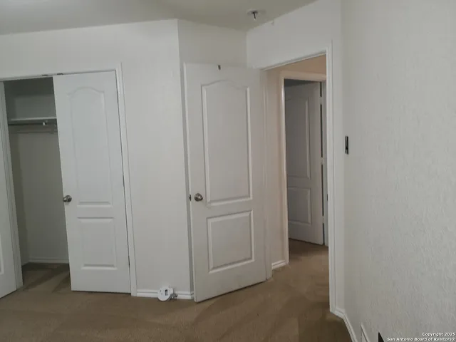 a view of a livingroom and an empty room