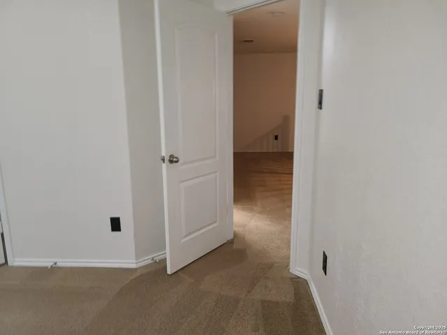 a view of an empty room with stairs